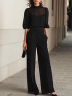 Valentina | Conjunto negro de tres piezas, compuesto por un top camisola transparente y pantalones de pernera ancha.”